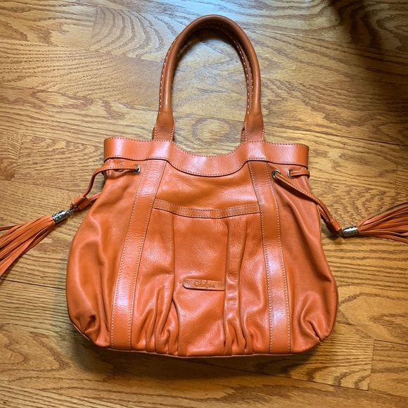 Cole Hahn orange handbag with fringe and silver hardware. - Picture 10 of 16